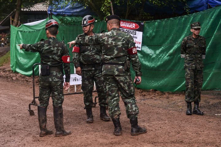 Thai soldiers speak at the Tham Luang cave area as operations continue for the 12 boys and their coach trapped at the cave in Khun Nam Nang Non Forest Park in the Mae Sai district of Chiang Rai province.