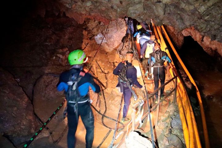 <strong>Thai rescue team members walk inside the cave</strong>