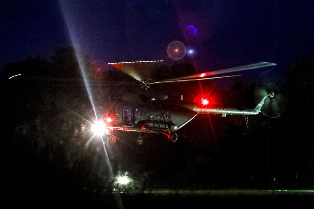 A helicopter believed to be carrying some of the rescued boys, lands at a military airport in Chiang Rai