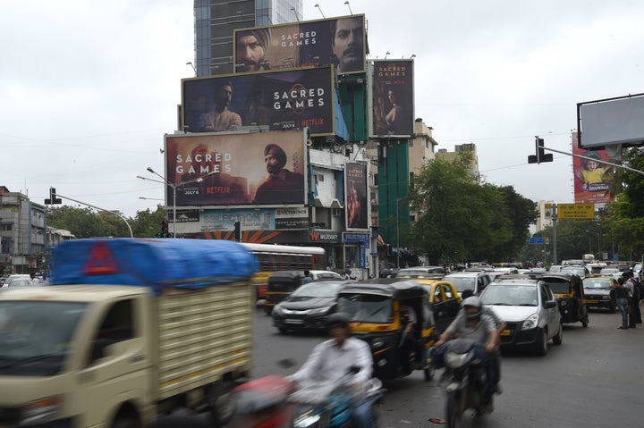 Commuters in Mumbai travel past large billboards for "Sacred Games," India's first Netflix original series, on Wednesday. 