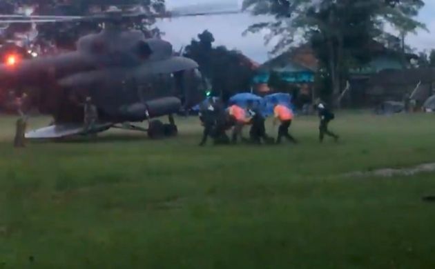 Rescuers stretcher what is believed to be one of the rescued boys to a helicopter 