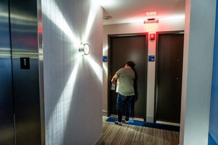 Jenyffer Ortiz opens her door at the Holiday Inn Express in the Bronx. 