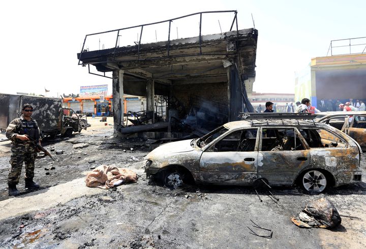 Afghan security forces inspect the site of a suicide attack in Jalalabad, Afghanistan on Tuesday.
