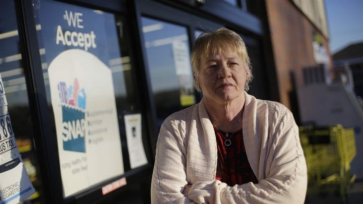 A woman stands outside a store that accepts food stamps in Bon Aqua, Tennessee. The farm bill being considered in Congress could greatly expand work requirements for food stamp recipients. States could be required to provide job training programs. 