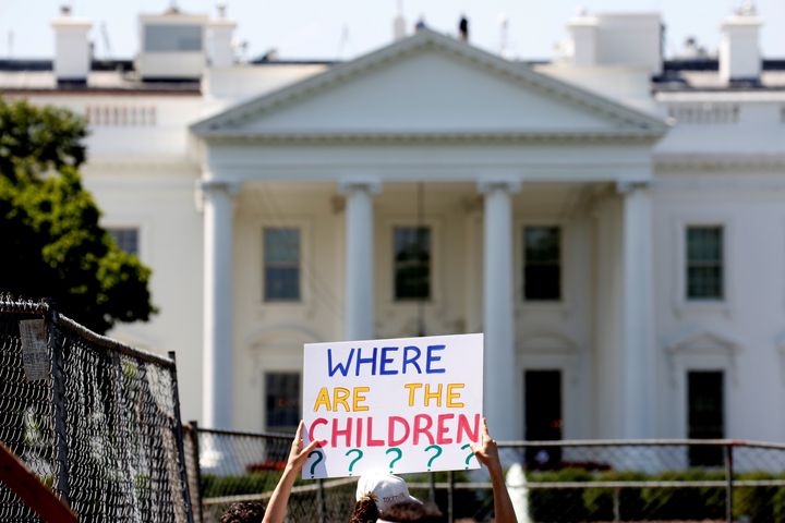 An immigration activist holds a sign against family separation during a rally in June to protest the Trump administration's immigration policy outside the White House.