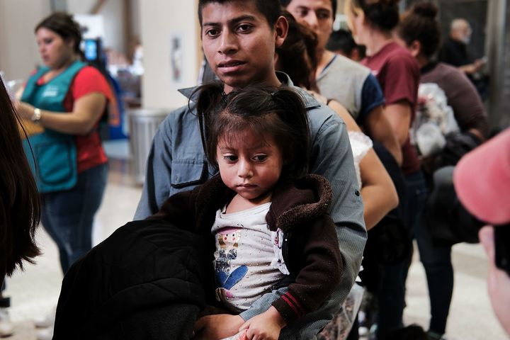 Women, men and children, many fleeing poverty and violence in Honduras, Guatemala and El Salvador, arrive at a bus station following release from Customs and Border Protection on June 23 in McAllen, Texas.