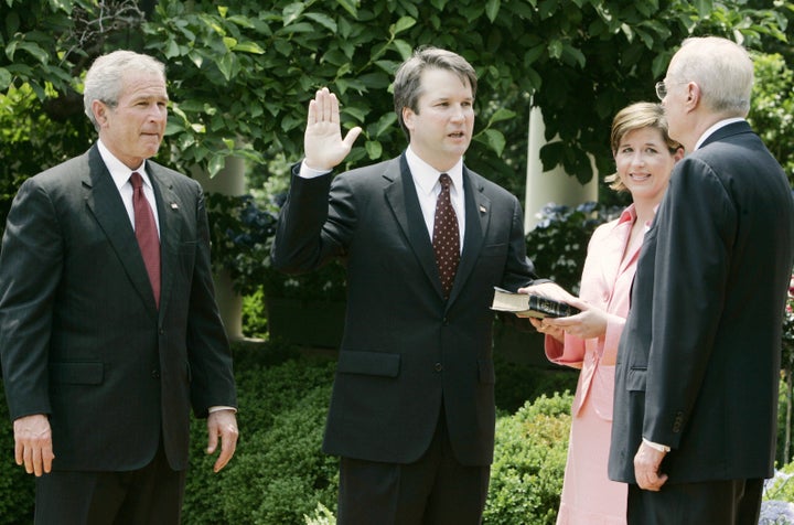 (From left) President George W. Bush, Brett Kavanaugh and his wife, Ashley Estes Kavanaugh, at his swearing-in as a judge for the U.S. Court of Appeals for the District of Columbia by Justice Anthony Kennedy at the White House in 2006.