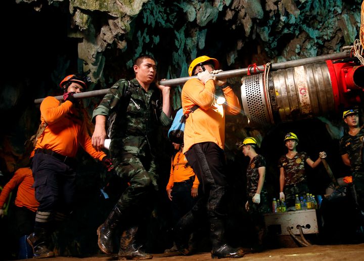 Rescue workers and soldiers take out machines used during the rescue of the Wild Boars football team following the successful operation to free them
