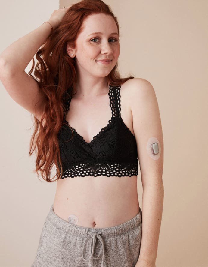 A woman with Type 1 diabetes models a bralette while using an insulin pump.