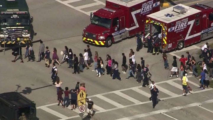 A still image in a video from WSNV.com shows students being evacuated from Marjory Stoneman Douglas High School on Feb. 14, 2