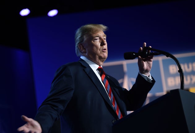 Trump gestures as he addresses a press conference at the nato summit.