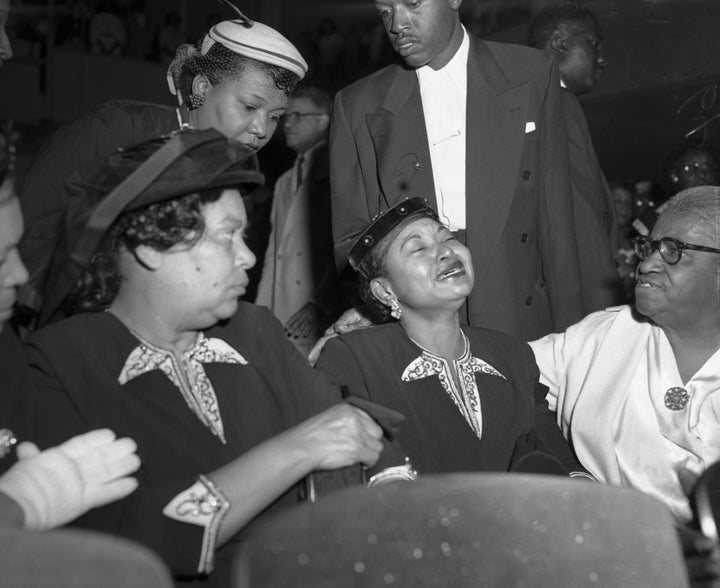 Mamie Bradley (center), Emmett Till's mother, at his funeral. She insisted on having an open casket funeral for him so the world could see what was done to him.