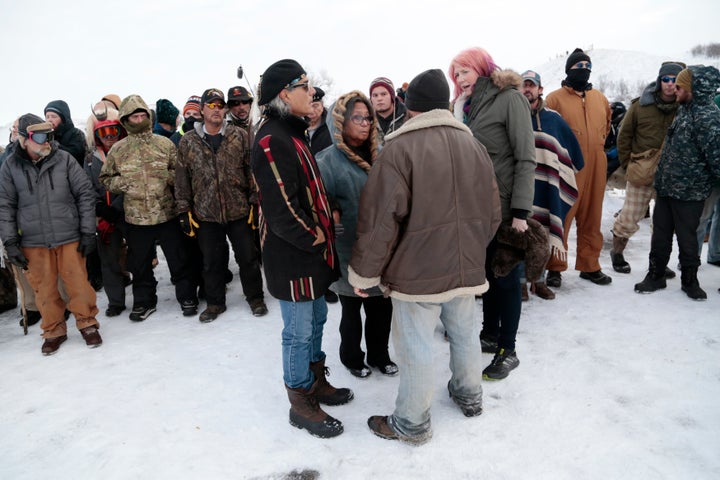 Phyllis Young of the Standing Rock Sioux tribe, center, talks with veterans who oppose the Dakota Access pipeline and local law enforcement on Backwater Bridge near Cannon Ball, North Dakota, on Dec. 2, 2016. 