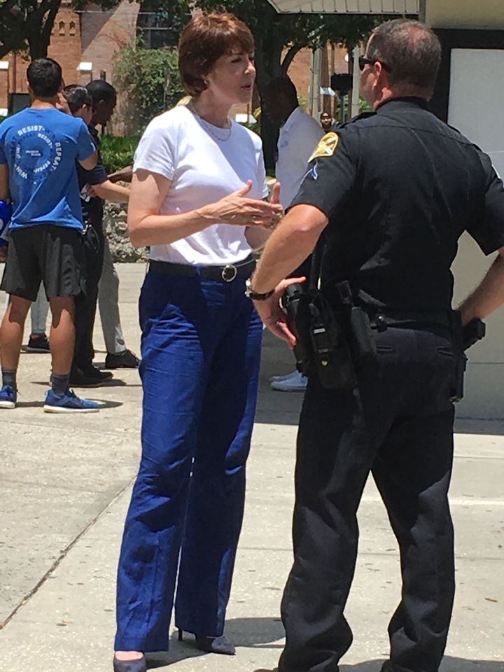 Former congresswoman and Florida Democratic candidate for governor Gwen Graham speaks with a Saint Petersburg police officer following a March For Our Lives rally. Four of the five Democratic candidates running appeared and denounced the National Rifle Association.