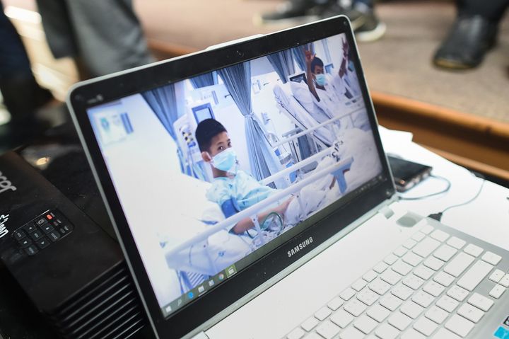 A laptop projecting video of the rescued soccer players at a press conference in Mae Sai, Thailand, July 11. The Wall Street Journal reported that their coach taught them meditation techniques to try to keep them calm.