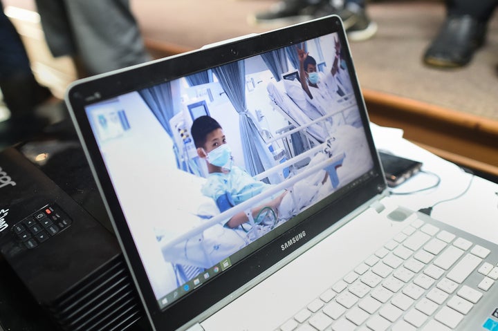 A laptop projecting video of the rescued soccer players at a press conference in Mae Sai, Thailand, July 11. The Wall Street Journal reported that their coach taught them meditation techniques to try to keep them calm.