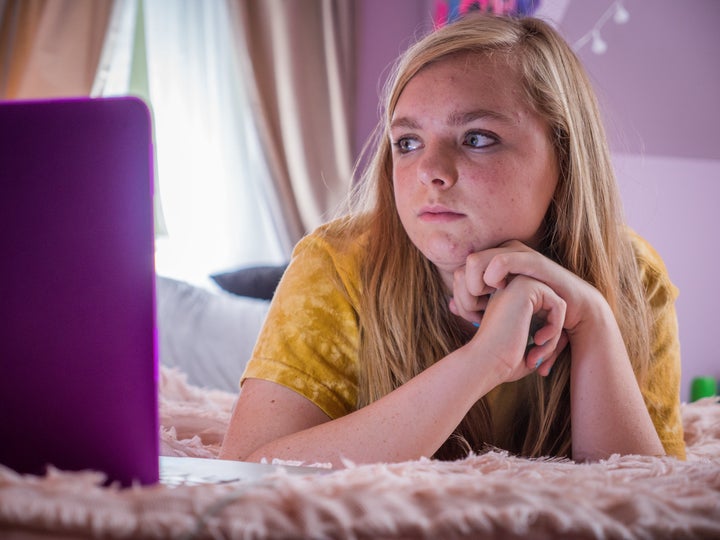 Kayla at home with her omnipresent computer screen