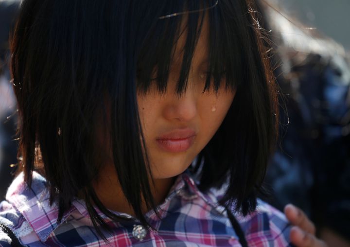 Ten-year-old Naomi Lien cries as she takes part in a statement to the media about immigration outside the Supreme Court on June 26. her Indonesian father had been detained by immigration authorities. The Trump administration is increasingly targeting Southeast Asians.