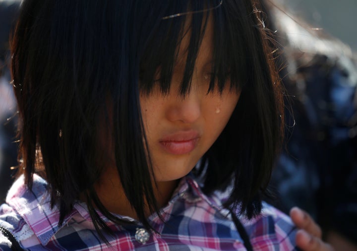 Ten-year-old Naomi Lien cries as she takes part in a statement to the media about immigration outside the Supreme Court on Ju