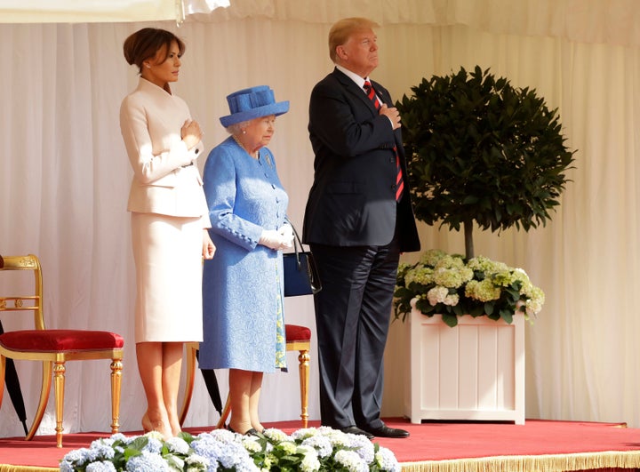 The Trumps stand alongside Queen Elizabeth II as they listen to the US national anthem at Windsor Castle. 