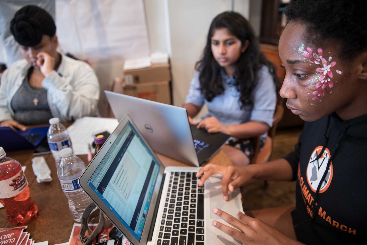 Elsa Mengistu of Greensboro, North Carolina, 16, Nadia Nazar of Baltimore, Maryland, 16, and Mikaela Hutchinson, of Hunterdon, New Jersey, 15, left to right, prepare for the first Youth Climate March.