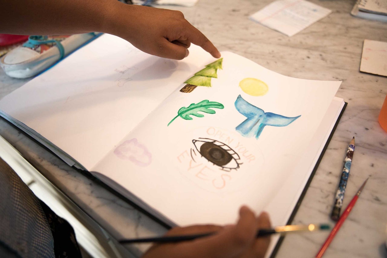 Nadia Nazar creates artwork to be used by marchers.
