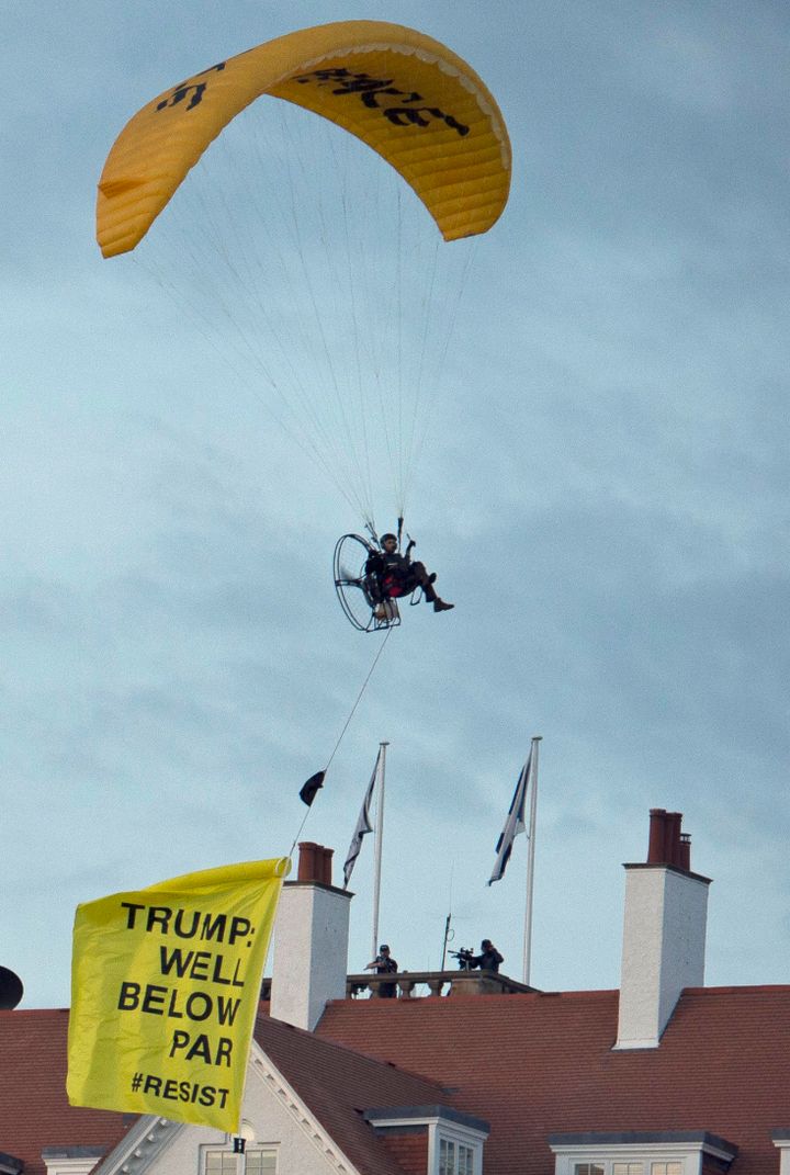 The Greenpeace protester flies a microlight