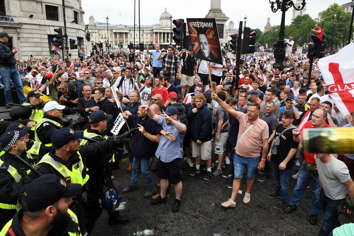 Demonstrators clash with police during an earlier Free Tommy Robinson rally in London on June 9