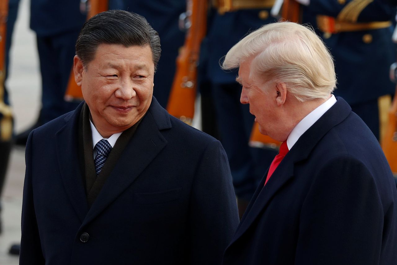 U.S. President Donald Trump takes part in a welcoming ceremony with China's President Xi Jinping.