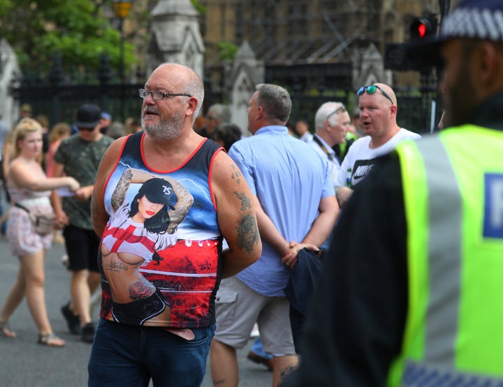 People stand in the road as supporters of English Defence League founder Tommy Robinson demonstrate in London.