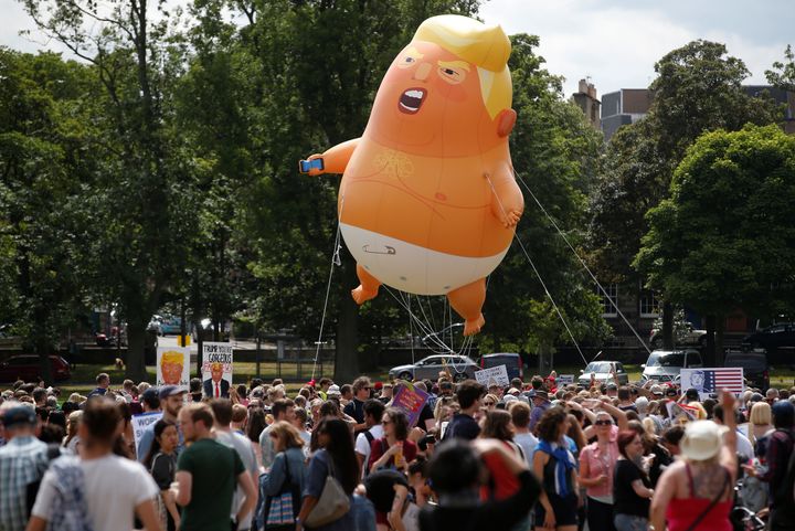 A small blimp resembling Donald Trump floats above demonstrators in Edinburgh, Scotland, on Saturday protesting the U.S. president.