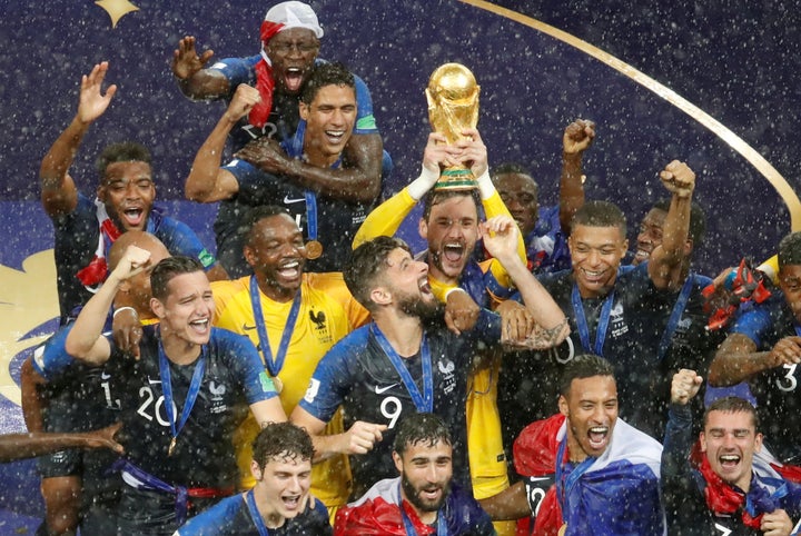 France's Hugo Lloris lifts the trophy as his team celebrates winning the World Cup in Moscow on Sunday night.