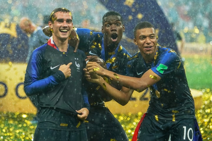 Kylian Mbappe, Antoine Griezmann and Paul Pogba show off the two stars on their shirts, signifying a second World Cup win for France.