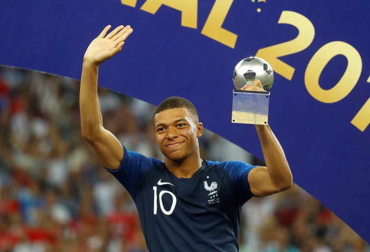 Mbappé, 19, receives the FIFA Young Player award following France's World Cup victory.