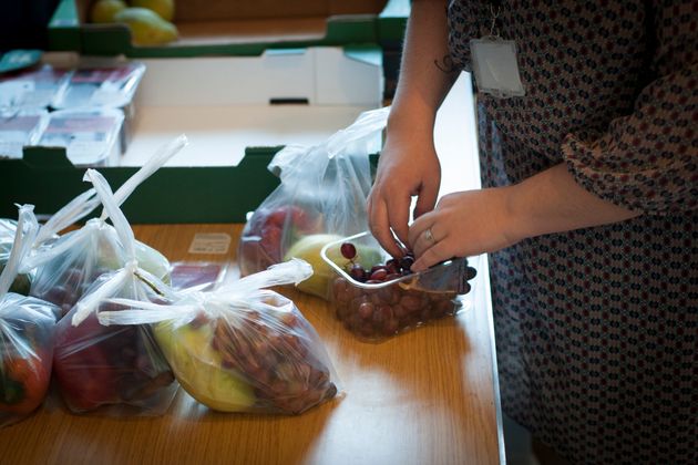 Volunteers pack fruit bags in a Liverpool foodbank. 