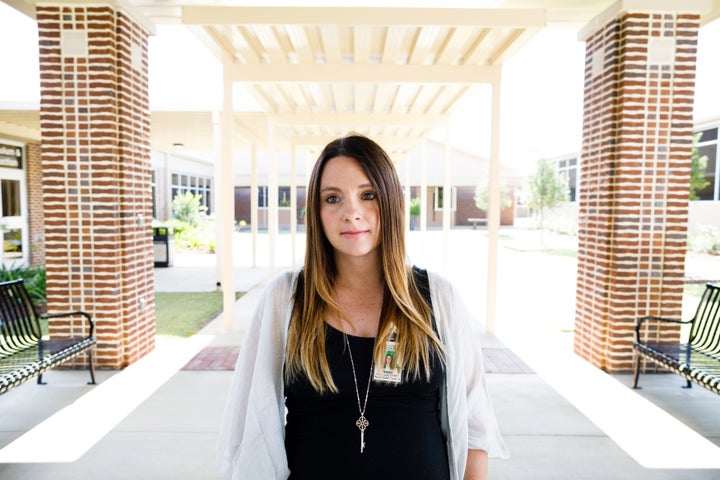 Boatright outside of the entrance to the Board of Education building where she works in Thomasville.