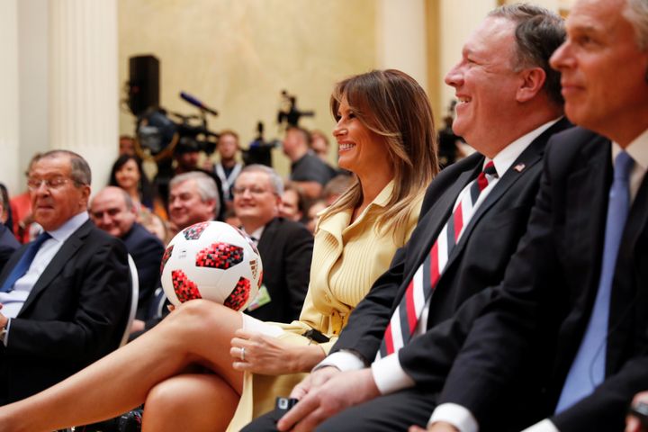 First Lady Melania Trump smiles as she holds a football thrown to her by US President Donald Trump during his joint news conference with Russia's President Vladimir Putin.