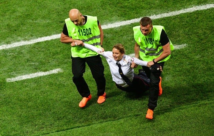 A pitch invader, a member of the Russian protest-art group Pussy Riot, is escorted by stewards during the Russia 2018 World Cup final football match between France and Croatia at the Luzhniki Stadium in Moscow on July 15, 2018.