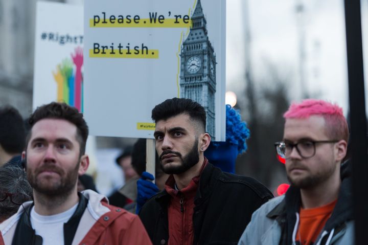 BeLeave and Cambridge Analytica whistleblowers Shahmir Sanni (C) and Chris Wylie (R) attend a demonstration in Parliament Square.