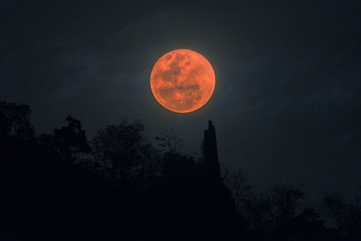 A blood moon eclipse over a mountain in Thailand on Jan. 31, 2018.