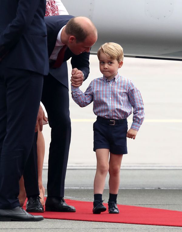 Prince William speaks with Prince George of Cambridge as they arrive&nbsp;on the first day of&nbsp;their official visit to Po