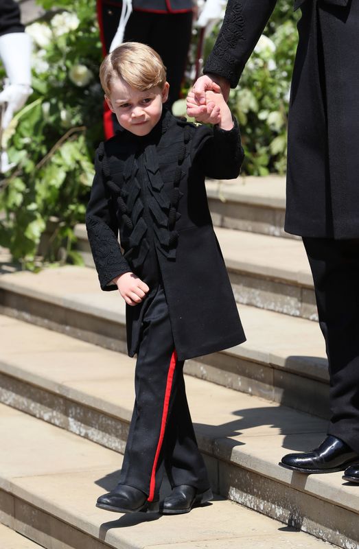 May 2018: Prince George looks uncomfortably warm in his pageboy's outfit for the wedding of uncle Harry and Meghan Markle. This is the face of a boy who would rather be running around an air-conditioned Toys 'R' Us.