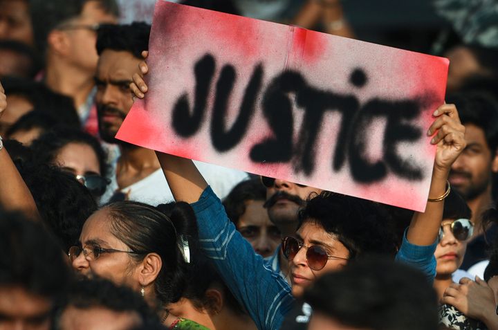 People hold signs as they participate in a protest against the Kathua, Unnao, rape cases and other incidents of rape in India on April 15, 2018 in Mumbai, India. 