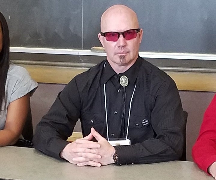 Anthony Bouchér wearing special pink glasses that help protect what little eyesight he has left.
