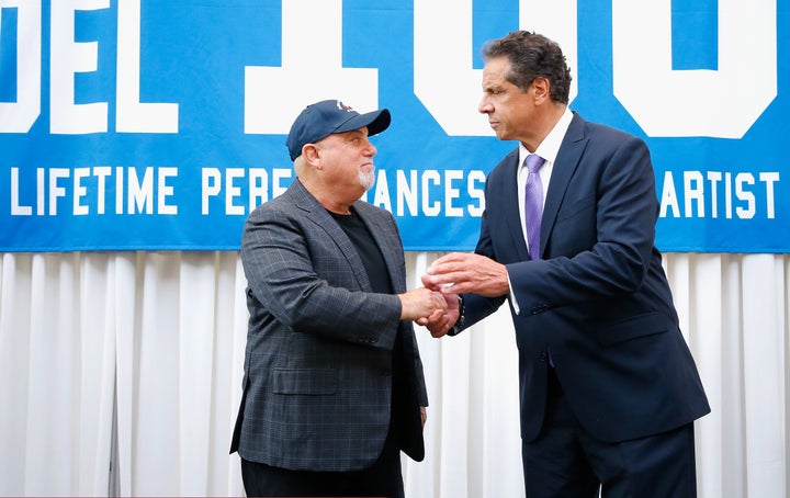 New York Gov. Andrew Cuomo (D), right, congratulates musician Billy Joel on his 100th show at Madison Square Garden in Manhattan. Joel and his wife Alexis are major Cuomo donors.