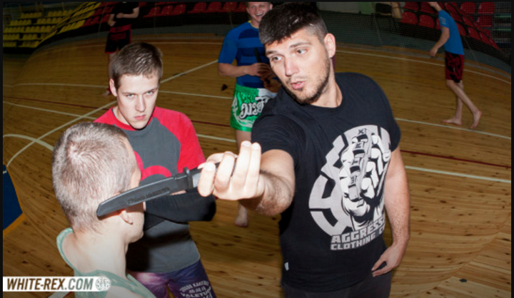 In a post from White Rex's Tumblr, a man in a White Rex shirt gives a "knife combat seminar."