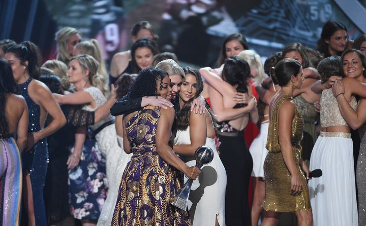 Sarah Klein, Tiffany Thomas Lopez, Aly Raisman and other recipients of the Arthur Ashe Award for Courage hug each other at the 2018 ESPYS in Los Angeles on Wednesday.