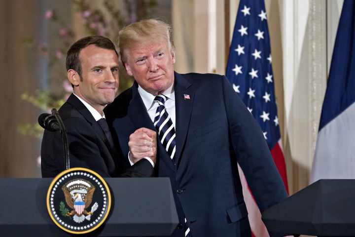 U.S. President Donald Trump embraces French President Emmanuel Macron during a news conference in the White House, April 24, 2018.
