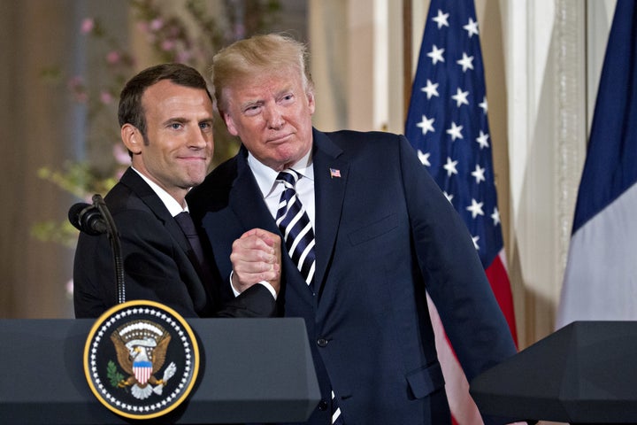 U.S. President Donald Trump embraces French President Emmanuel Macron during a news conference in the White House, April 24, 2018.