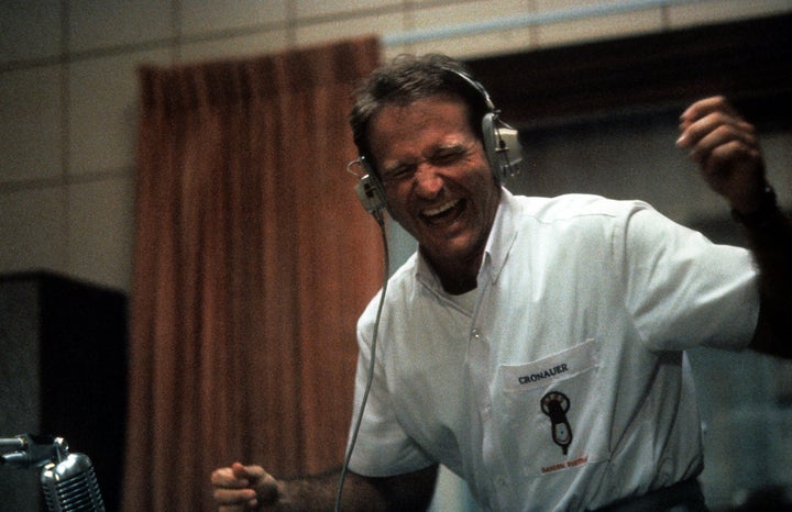 Robin Williams enjoying music through headset in a scene from the film "Good Morning, Vietnam," 1987.